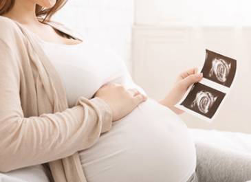 Women hold baby ultra sound