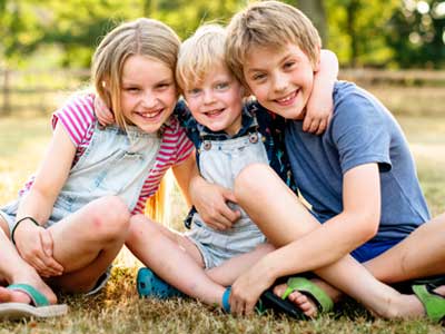 Three young siblings sitting together