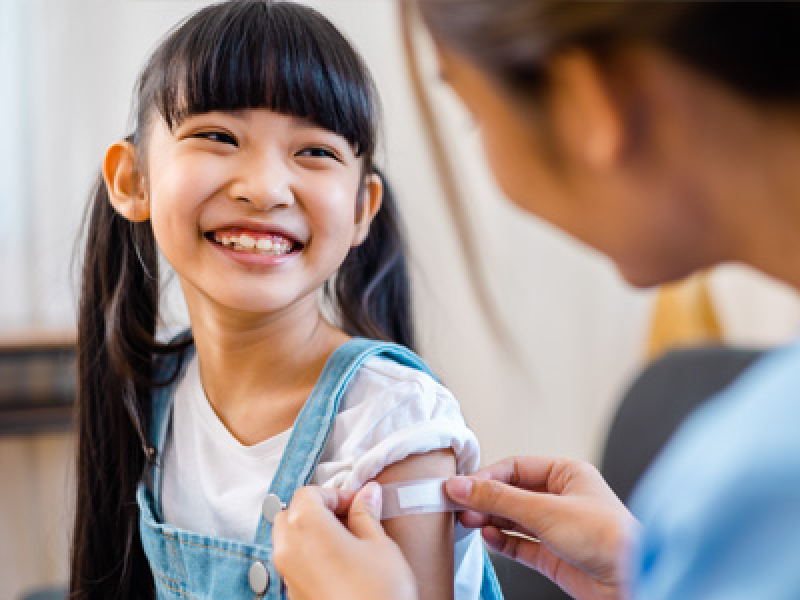 Girl getting a shot for health care professional